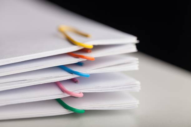 File folders with documents and bright paperclips