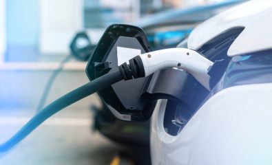 Plugged in chargers into two electric cars at charge station